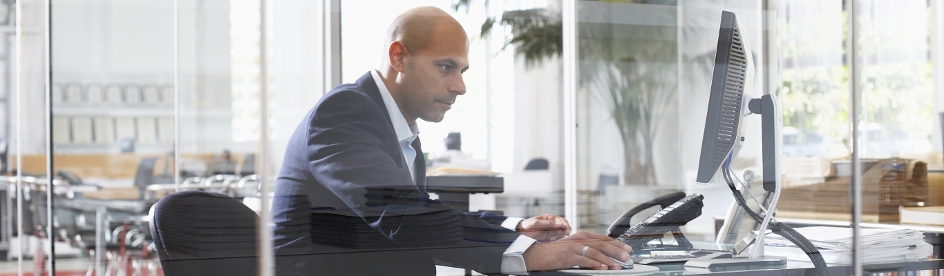 Man looking at computer in office